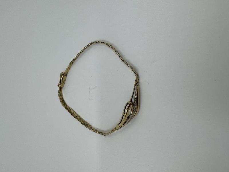 gull armbånd med små diamanter.